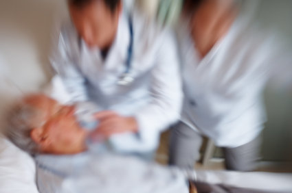 Emergency - Blurred image of a senior citizen getting a heart attack